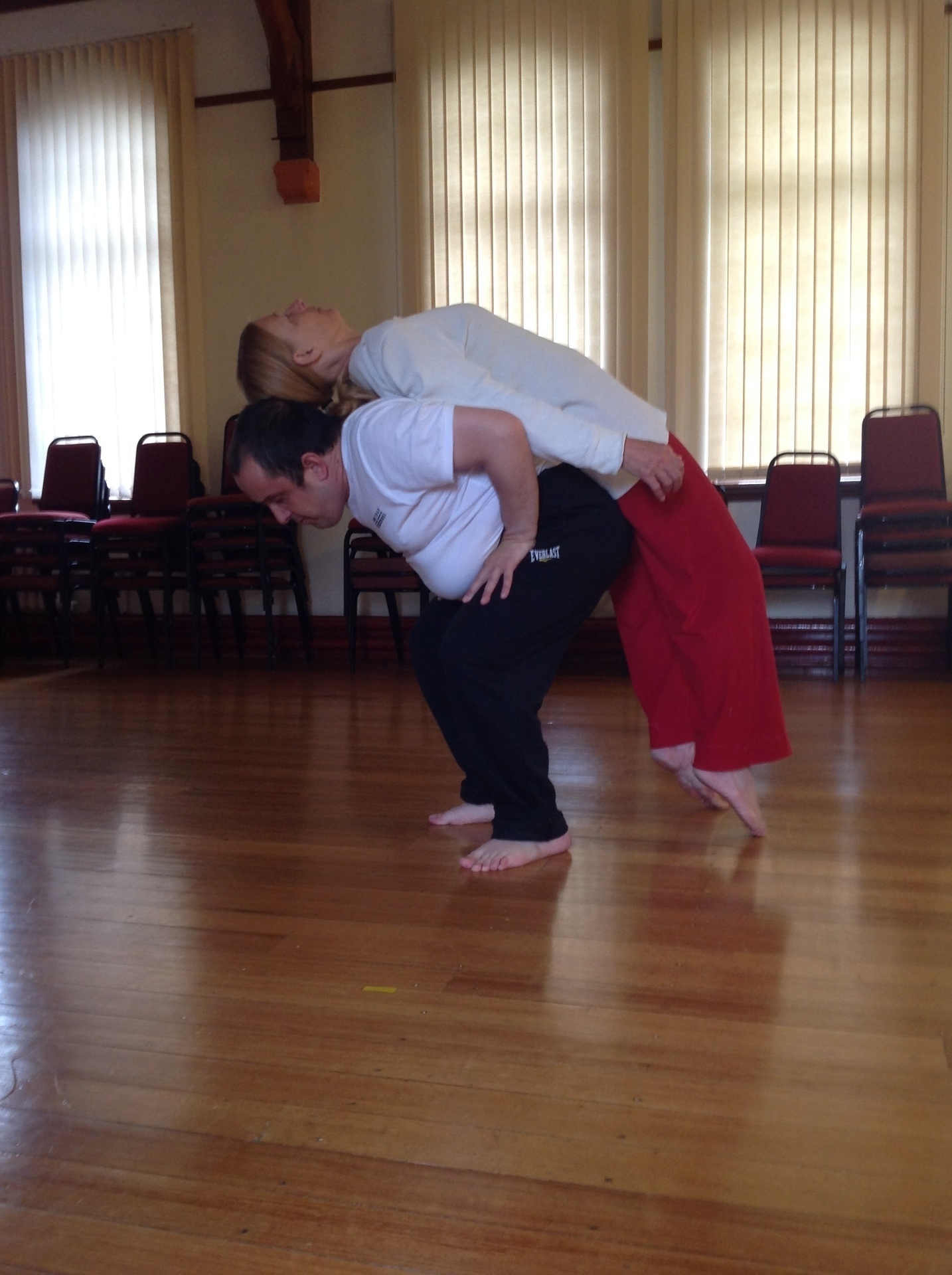 Photo of two people, dancing back to back